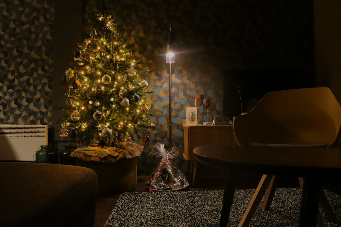 A decorated Christmas tree with a gift underneath.